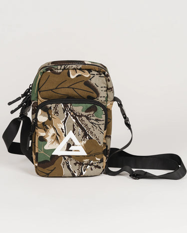 Camouflage crossbody bag with black adjustable strap and white Legacy G logo on the front pocket, shown on a white background.