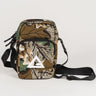 Camouflage crossbody bag with black adjustable strap and white Legacy G logo on the front pocket, shown on a white background.
