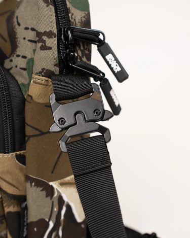 Close-up of the GB Tactical Cross Body Pack in camo, featuring a premium alloy buckle, durable nylon strap, and branded zipper pulls.