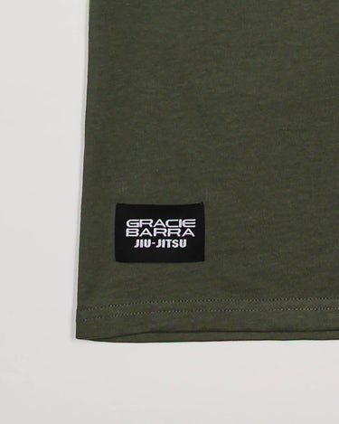 Close-up of hem with black woven Gracie Barra Jiu-Jitsu label on green Tactical Kids Tee.