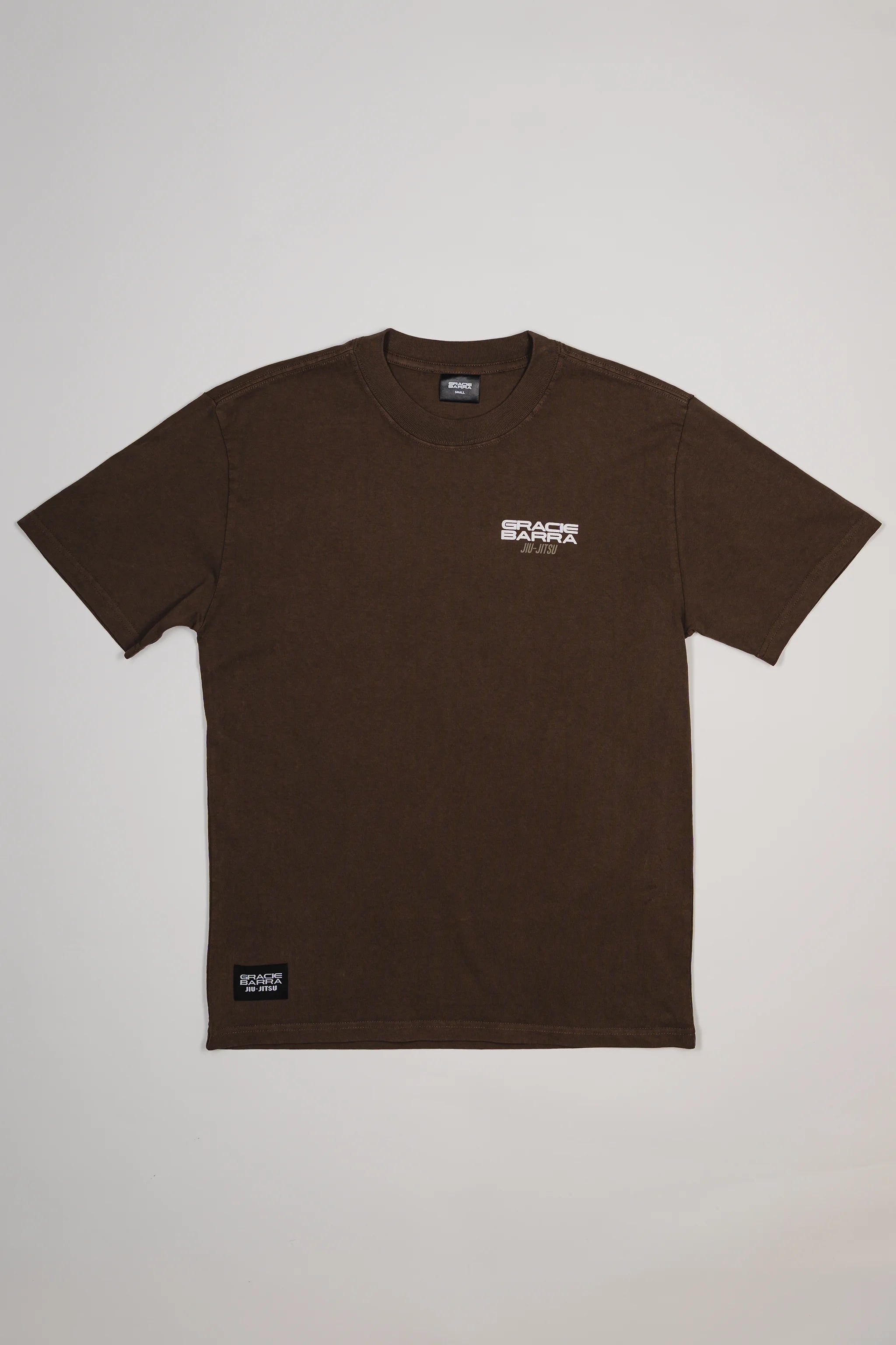 Front view of Tactical Men’s Tee in dark brown, featuring small Gracie Barra Jiu-Jitsu logo on the chest and woven label near the hem, displayed on a light gray background.