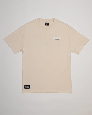 Front view of Tactical Men’s Tee in natural beige with white Gracie Barra Jiu-Jitsu logo on the chest, displayed on a light gray background.