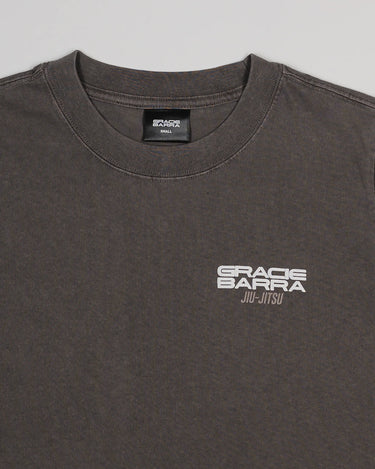 Close-up of the Tactical Women’s Tee in gray featuring the white Gracie Barra Jiu-Jitsu logo on the chest, displayed on a light gray background.