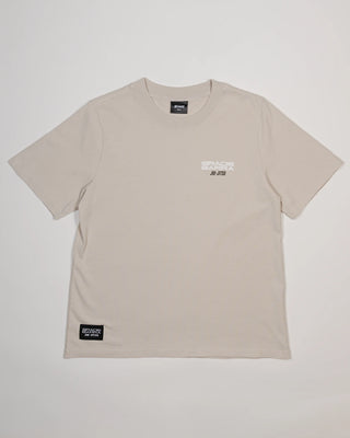 Beige Tactical Women’s Tee with minimalist logo on left chest, short sleeves, and crew neck on light background.