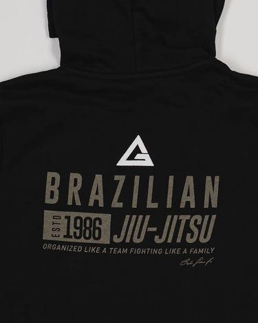Close-up of back print on black Tactical Women’s Zip Hoodie with Legacy G logo and “Brazilian Jiu-Jitsu” text.