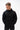 Technical Flow Mens Hoodie in black, front view on model, tonal Legacy G chest logo, drawstring hood and front pouch pocket with hands inside.