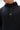 Technical Flow Mens Hoodie in black, close-up of chest showing tonal Legacy G logo and drawstring cords with branded metal aglet tips.