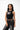 Unified Womens Tank, black — front three-quarter view showing the high ribbed neck and weathered chest graphic of the Legacy G over red-and-white stripes with the stacked Gracie Barra wordmark.