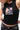 Unified Womens Tank, black — chest close-up of the weathered graphic: Legacy G over red-and-white stripes with the stacked Gracie Barra wordmark below.