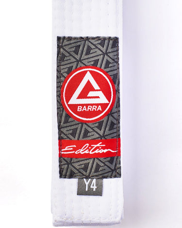 Close-up of the Youth White Belt showing the Red Shield patch, Edition label, and size tag with detailed stitching.