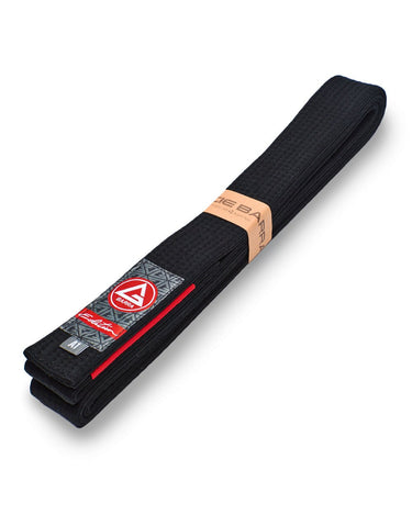 Folded black GB Edition Adult Belt displayed on a white background, featuring the Red Shield label, rank-stripe sleeve, and reinforced weave.