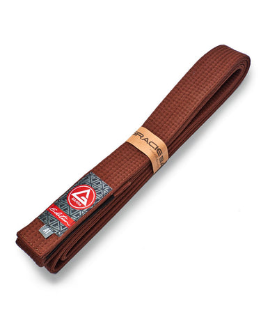 Brown GB Edition Adult Belt folded diagonally with the Red Shield patch and Edition label visible on a clean white background.