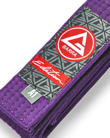 Close-up of the Purple GB Edition Adult Belt showing the Red Shield patch, Edition label, reinforced stitching, and size tag.