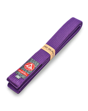 Folded purple GB Edition Adult Belt displayed diagonally with Red Shield patch, rank stripe sleeve, and size label.