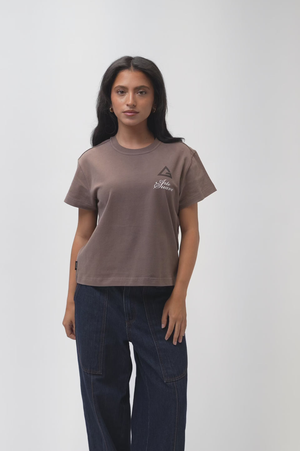 Arte Suave V3 Womens Tee in mocha, model turns to show the front chest print and the full Arte Suave back graphic with the Gracie Barra wordmark.