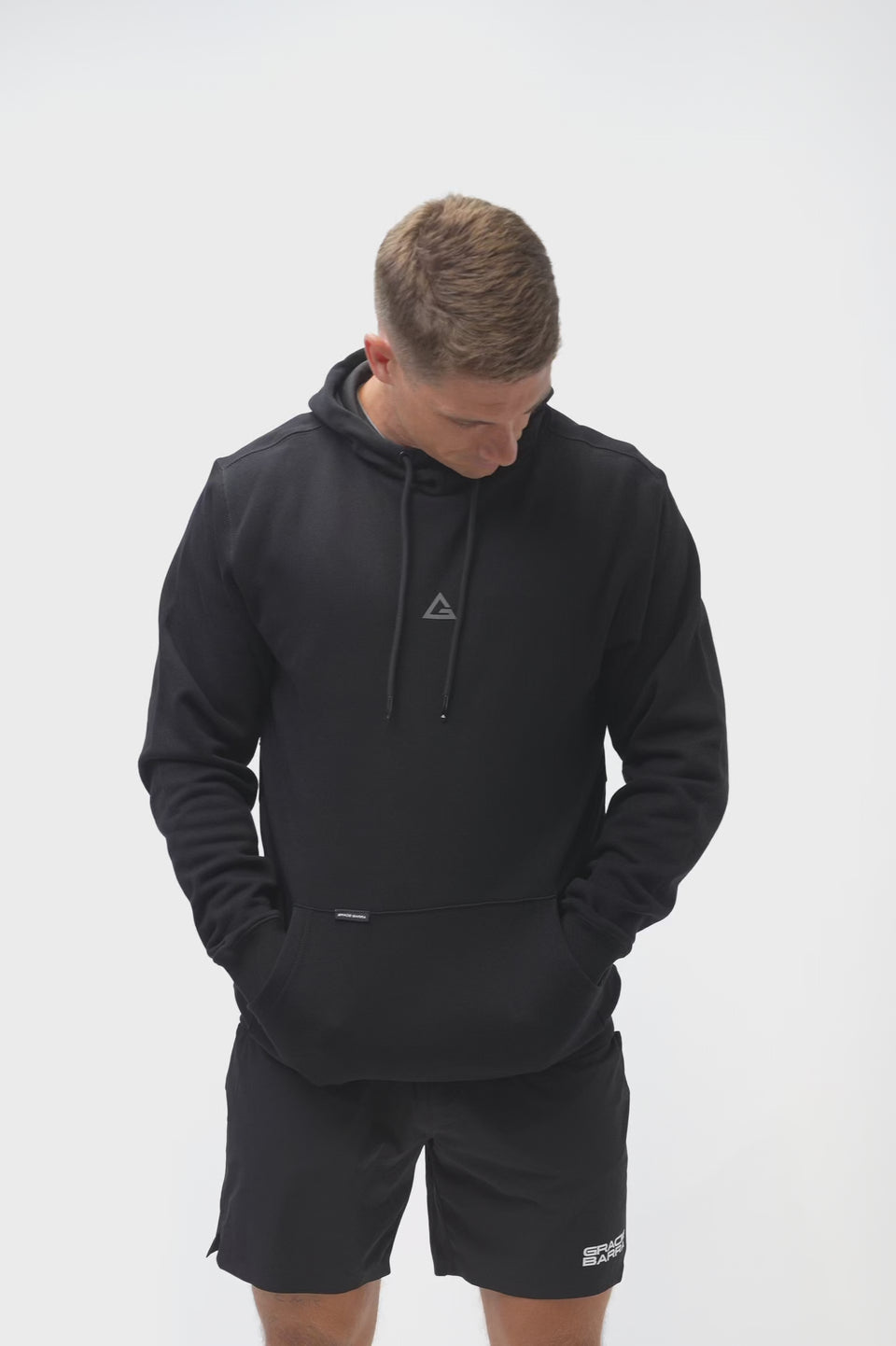Technical Flow Mens Hoodie in black, video of model showing front and back with tonal Legacy G chest logo and Gracie Barra wordmark at back hem.
