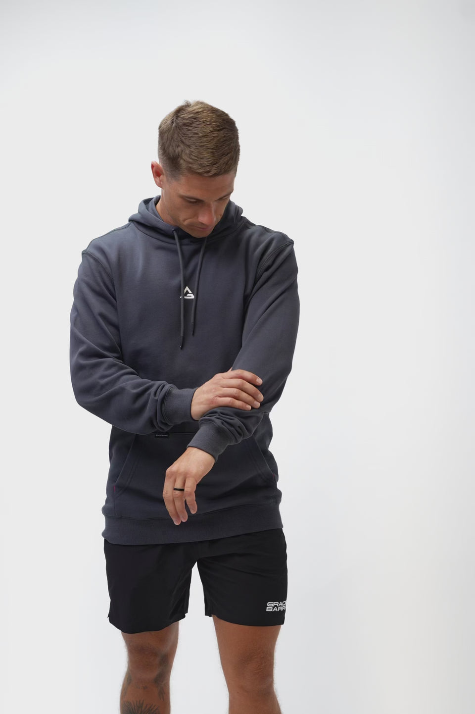 Technical Flow Mens Hoodie in slate, video of model showing front and back with white Legacy G chest logo and Gracie Barra wordmark at back hem.