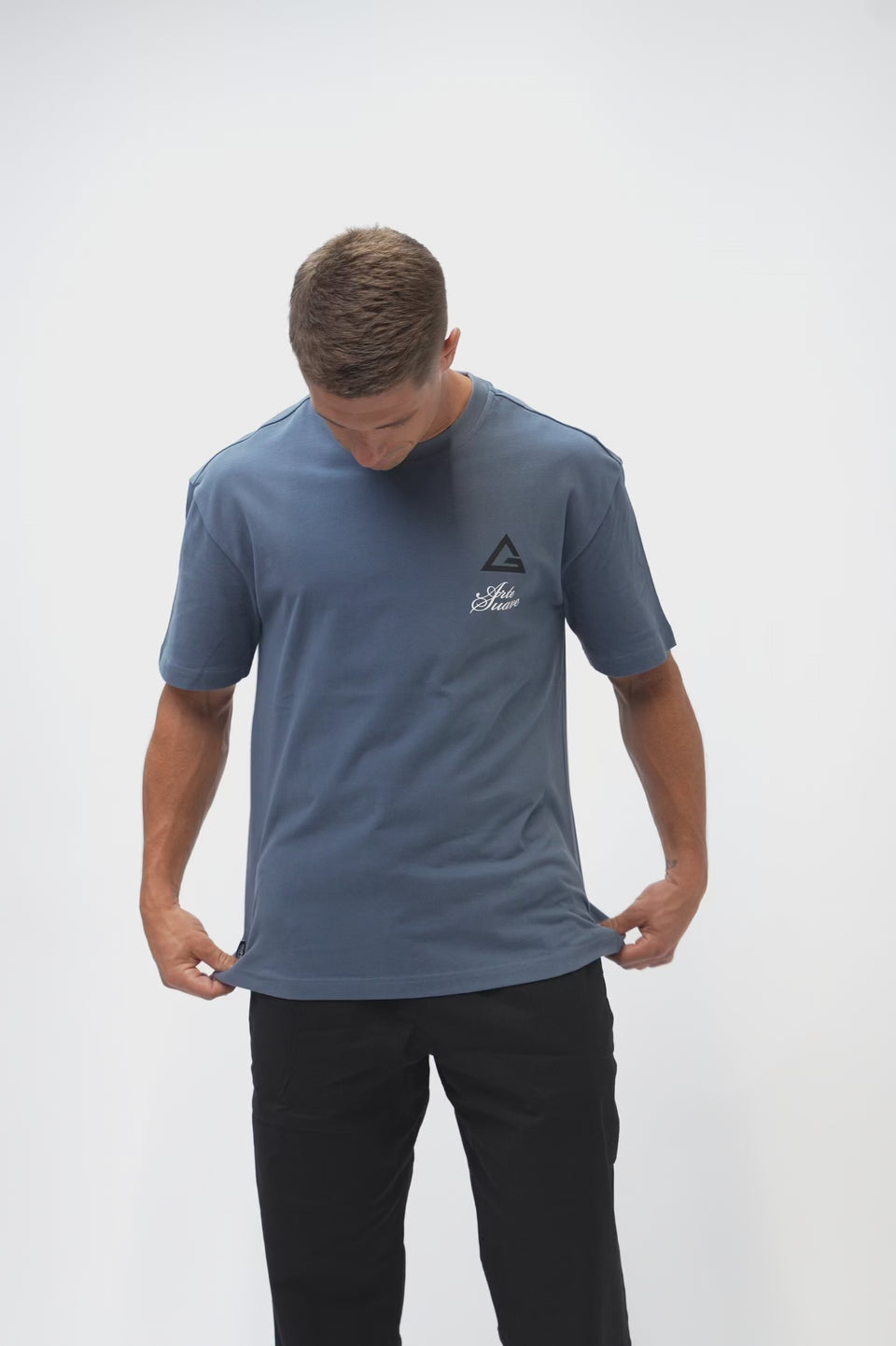 Arte Suave V3 Mens Tee in navy, model turns to show the front chest print and the full Arte Suave back graphic with the Gracie Barra wordmark.