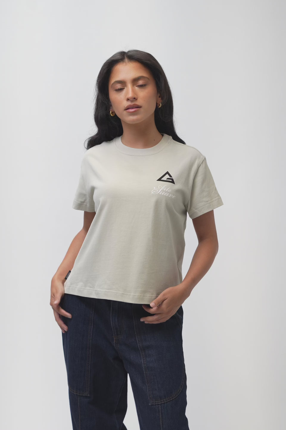 Arte Suave V3 Womens Tee in natural, model turns to show the front chest print and the full Arte Suave back graphic with the Gracie Barra wordmark.