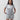 Video of a female model turning to show the front, back, and side of the Flow Women's Tech Tee in light grey and Frame Women's Short in light grey
