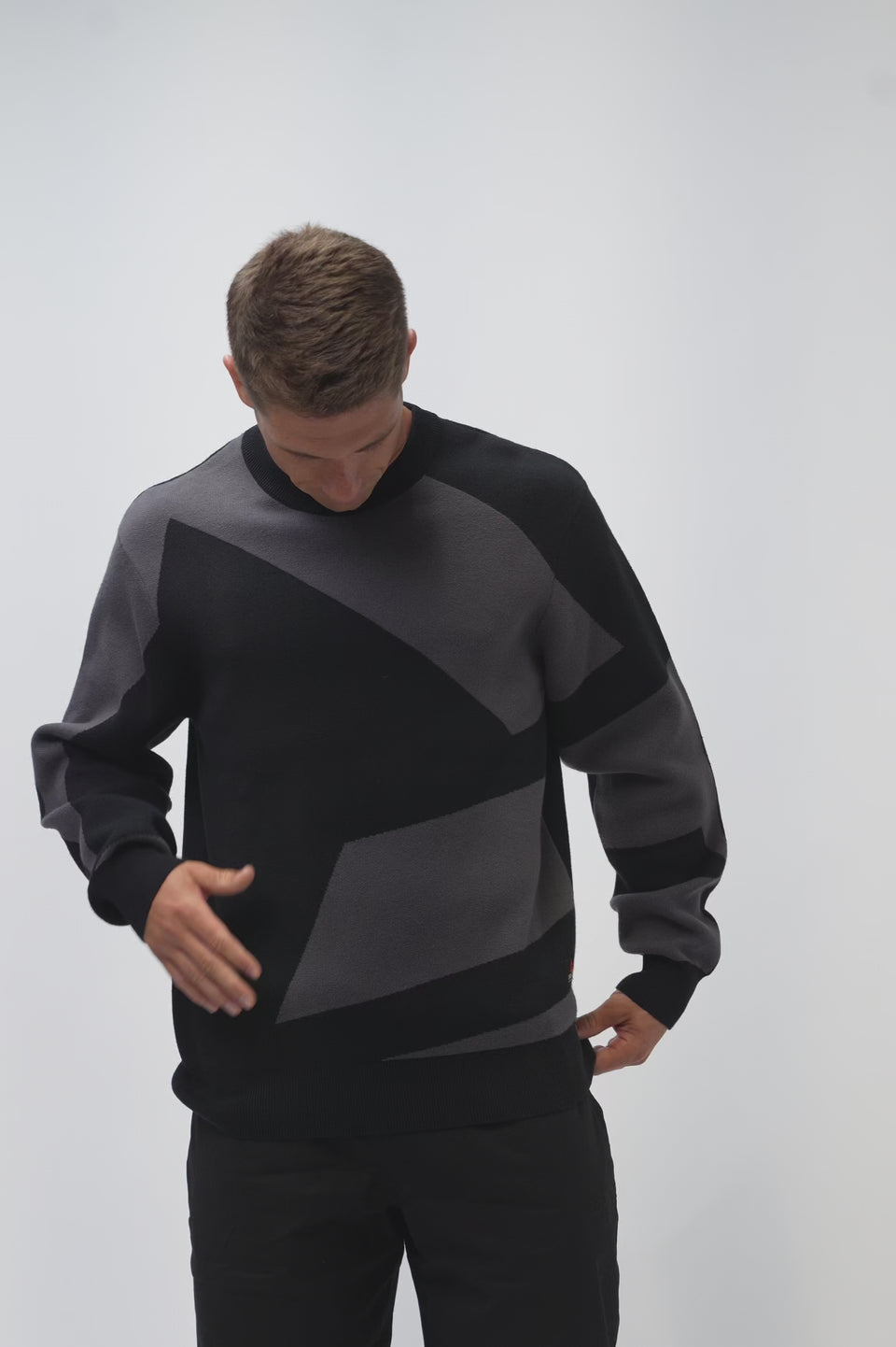 Legacy Mens Knit Sweater in black, video of model showing front, side and back with tonal jacquard-knit geometric pattern and Jiu-Jitsu back embroidery.
