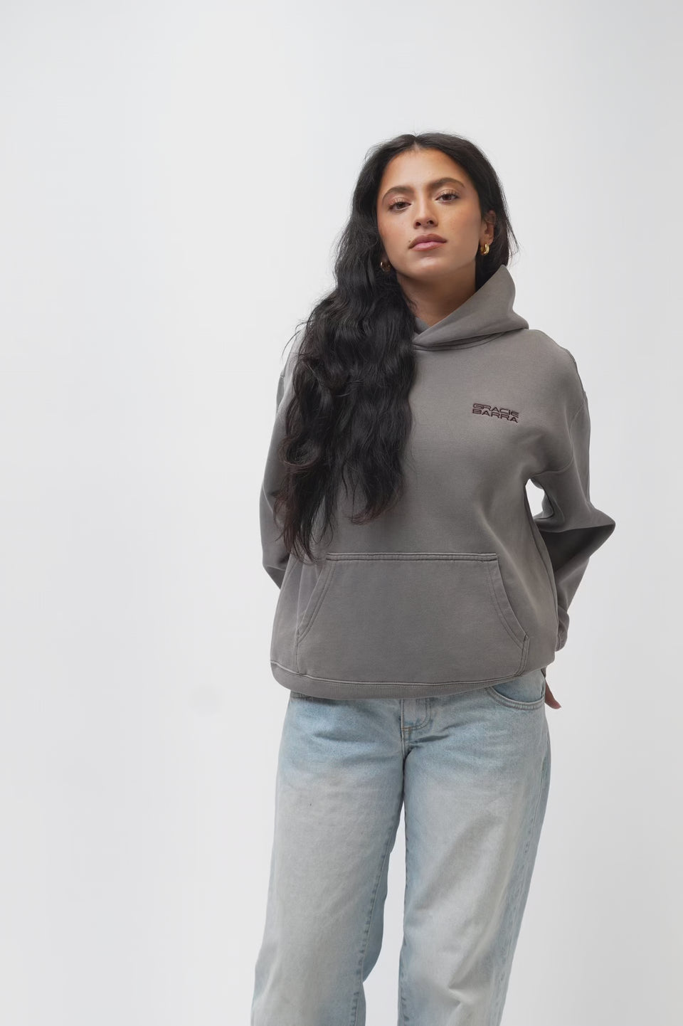 Emblem Womens Hoodie in Gray — video showing front, side, and back views with the tonal Gracie Barra chest emblem and Legacy G Jiu-Jitsu back graphic.