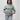 Video of the Arte Suave V3 Womens Hoodie in sage: model turns to show the Legacy G chest print and full-back 'Arte Suave' / 'Gracie Barra' graphic, then raises the hood.
