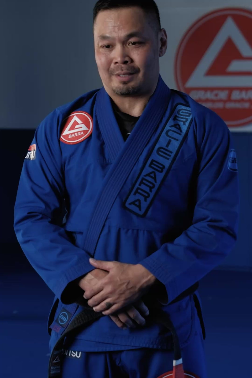 Gracie Barra Professor wearing the Ripstop kimono on the mat, giving a testimonial on the fabric and fit alongside training footage.
