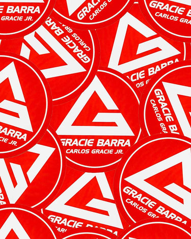 Collection of red GB Shield round stickers arranged across surface.